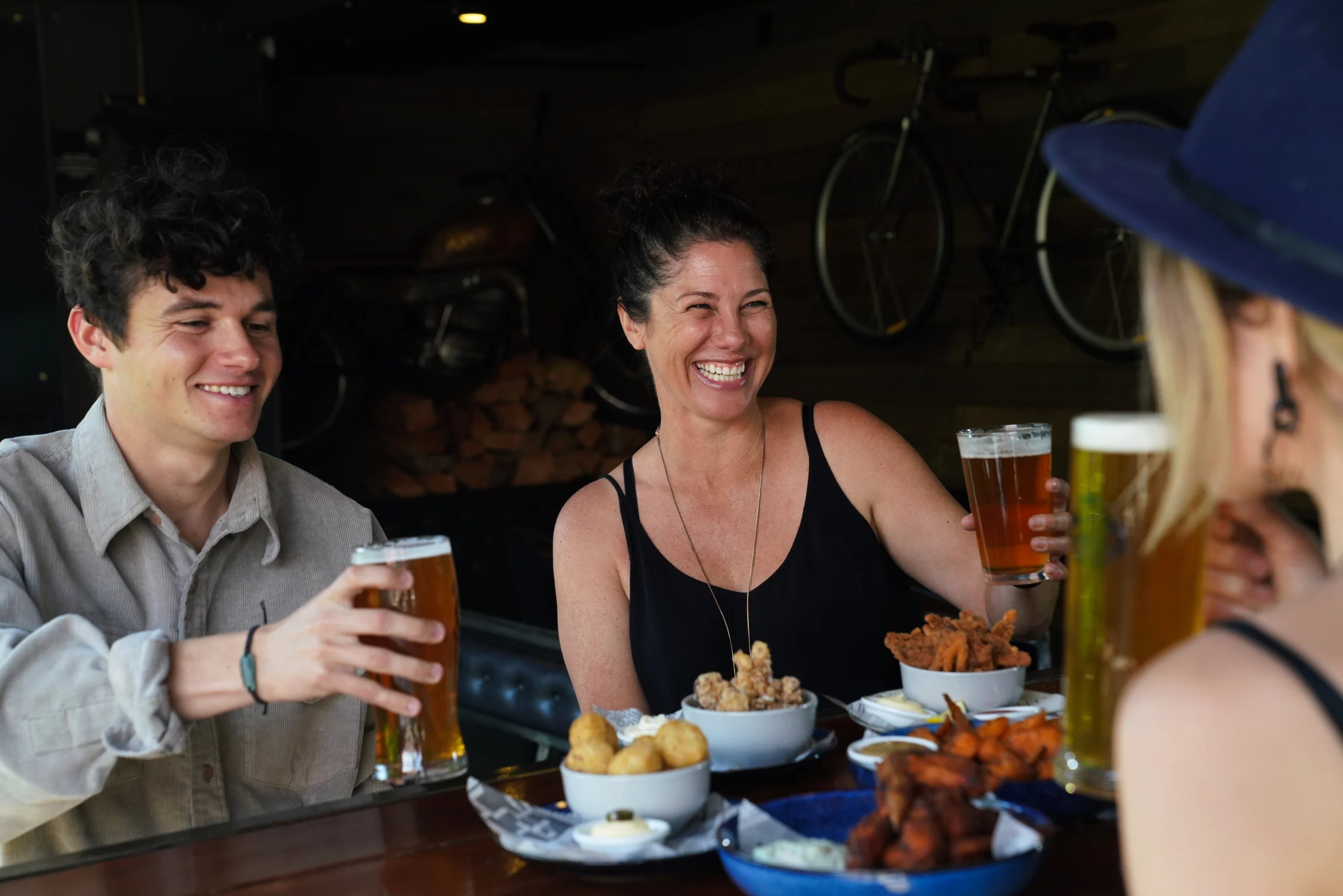 Outdoor seating at Woody's Sports Bar on a sunny day in Wānaka