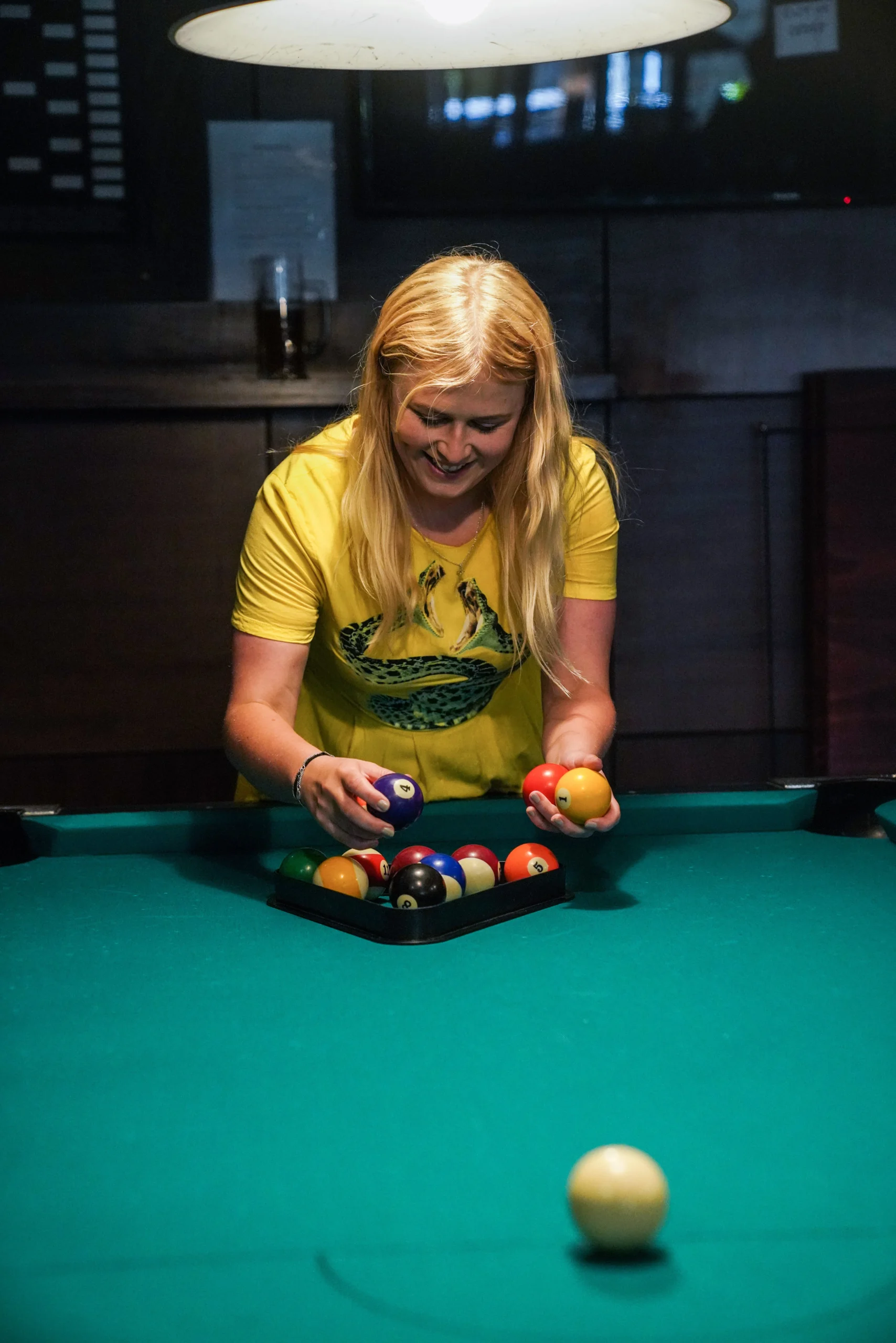 Spacious pool area at Woody's Sports Bar with cues and bar seating nearby